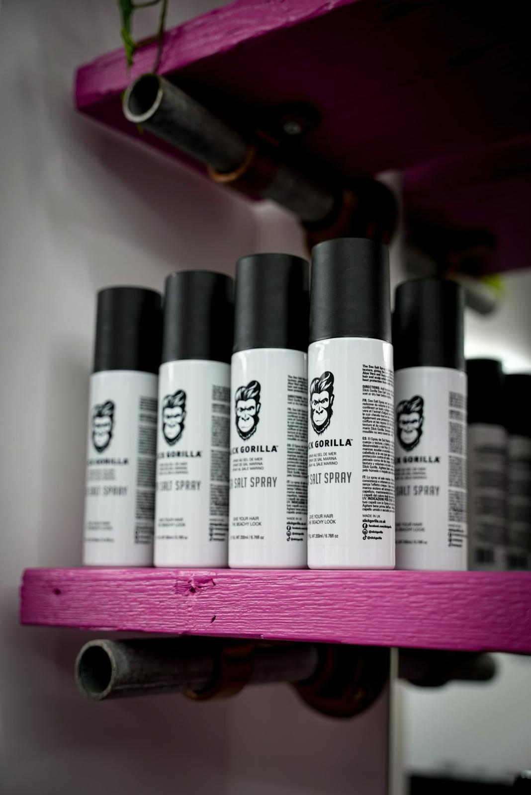 Barber products on pink shelving at ILL Fate Barber Co